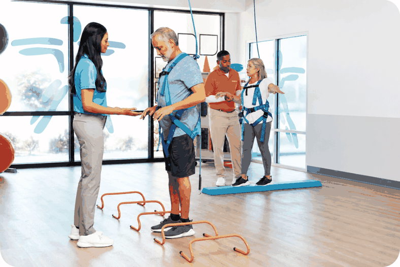 FYZICAL physical therapy session with patients completing balance and rehabilitation exercises with guidance from a therapist