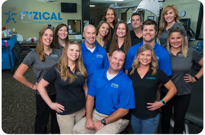 two brothers surrounded by their growing PT practice since joining FYZICAL