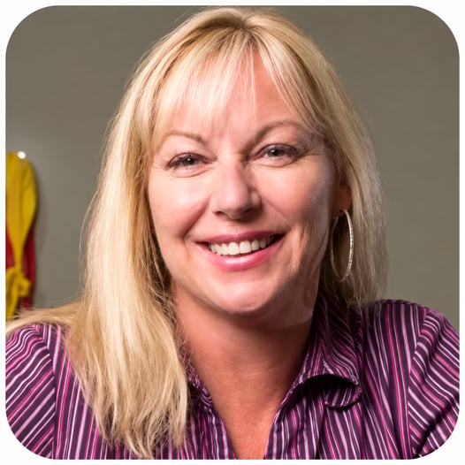 Gina Reuillon, FYZICAL franchise owner and physical therapist in Stuart, Florida, smiling for a professional portrait.