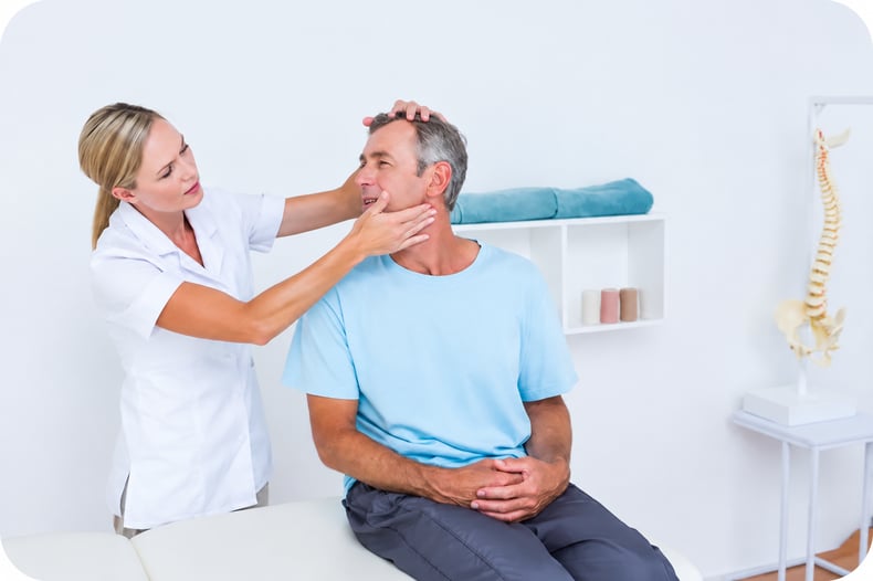 A physical therapist at their growing practice, stretching a patient's neck