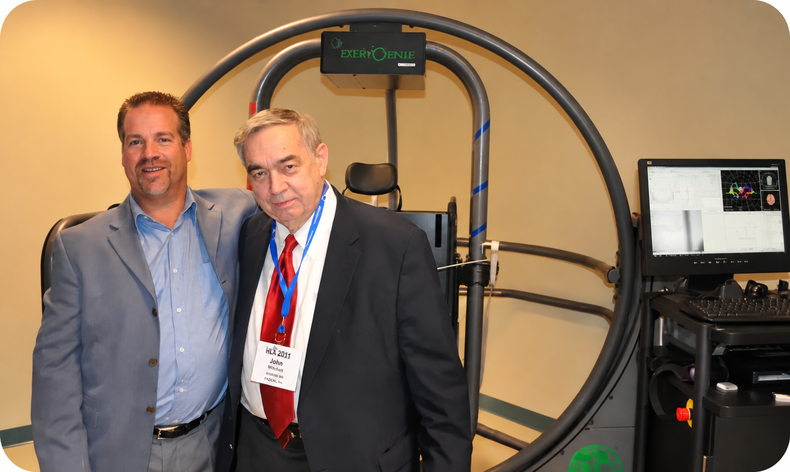 Franchisees posing in front of a therapy machine at the FYZICAL facility 
