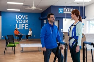 Physical Therapist talks to a patient working on her balance