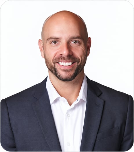 RJ Williams smiling in a professional headshot, wearing a dark suit jacket and white shirt against a white background.