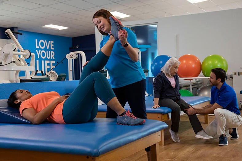 physical therapist stretching a patient's hamstring