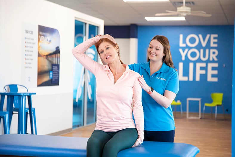 physical therapist working on stretching a patient's neck