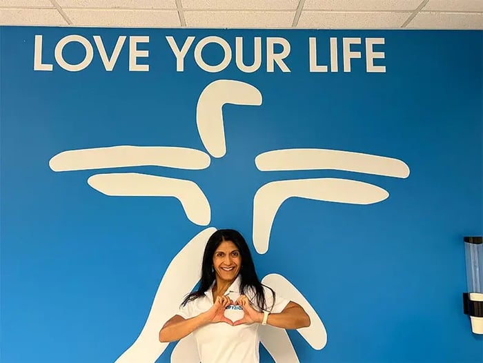 Therapist posing in front of a sign