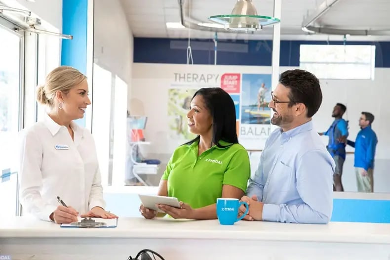 coworkers conversing at office table