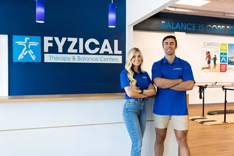 Two franchisees standing in front of Fyzical physical therapy practice