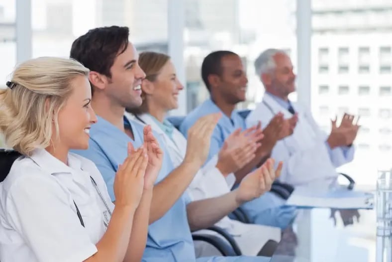 Medical team clapping  their hands during a meeting