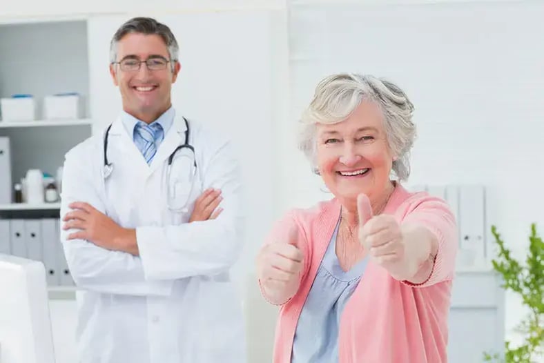 elder woman and doctor smiling