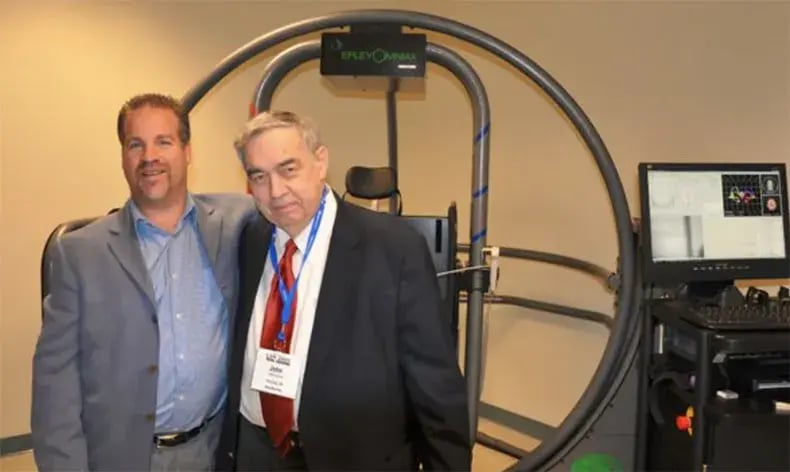 Franchisees posing in front of a therapy machine