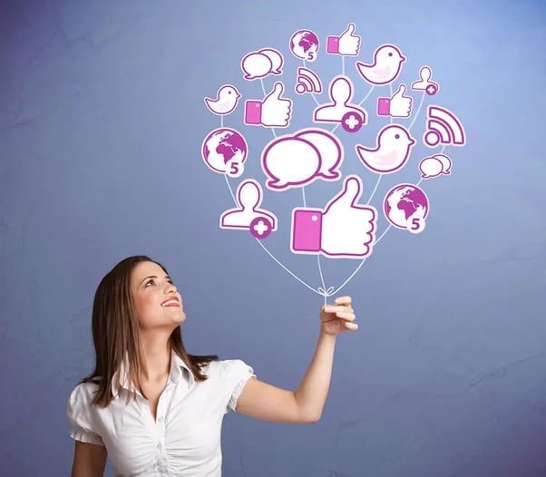 woman holding cluster of social media graphics