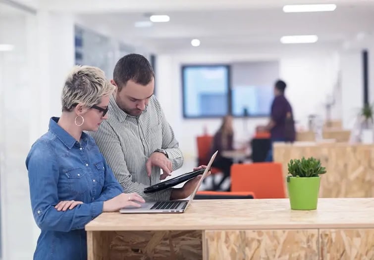 Coworkers collaborating on a laptop